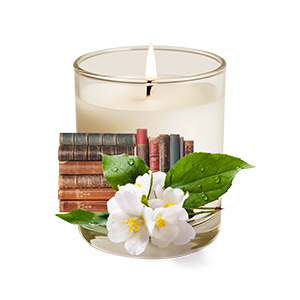 beige candle with old books and lilies